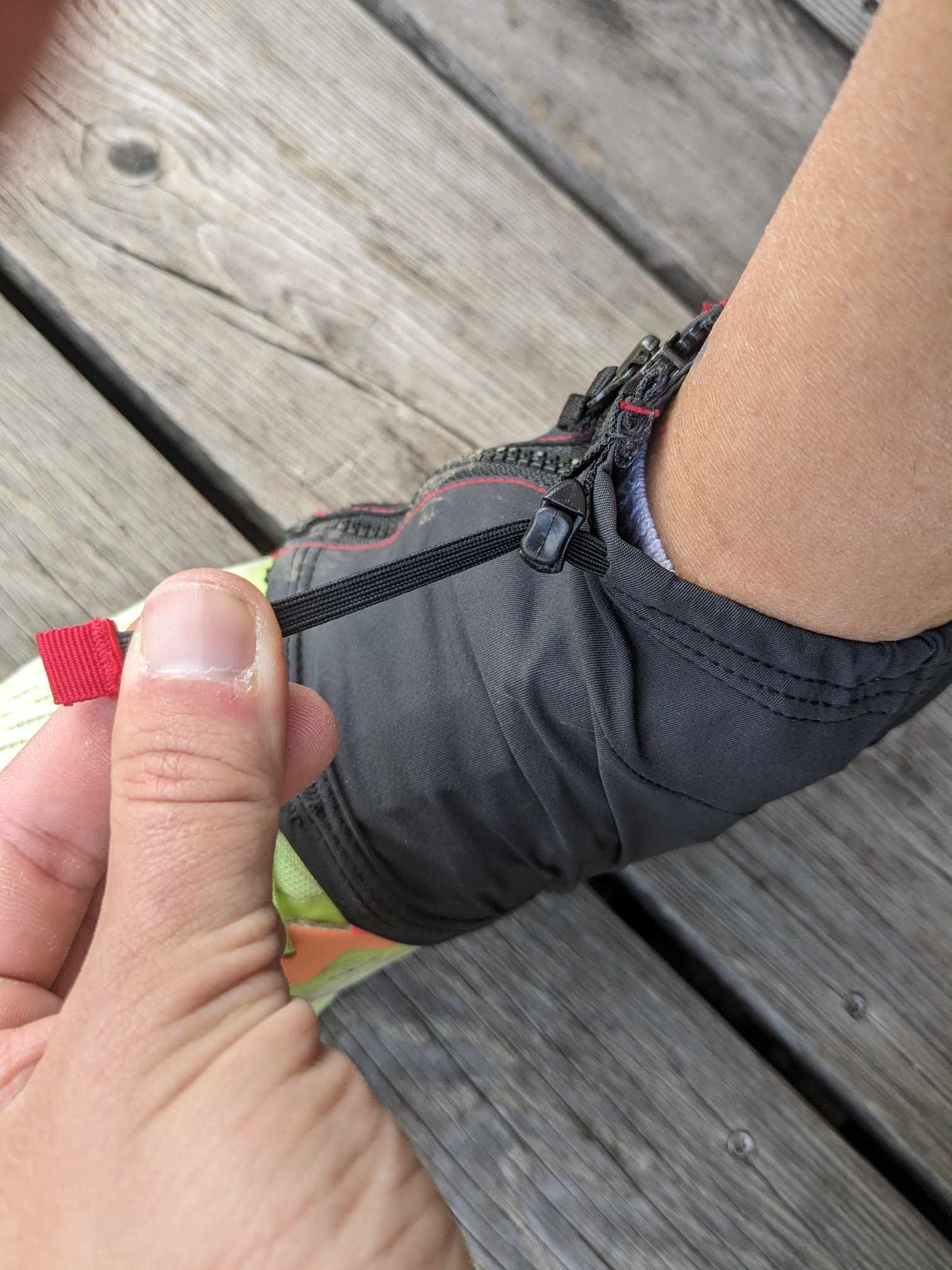 Man sieht, dass man die Gamasche oben, also am Bein, mit einem Gummizug eng ziehen kann